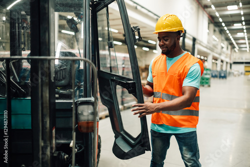 Warehouse worker closing forklift door after work shift