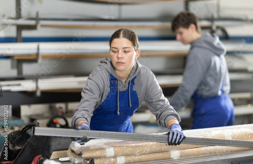 Canvastavla During work process, girl employee produces blanks for repairs and interior decoration