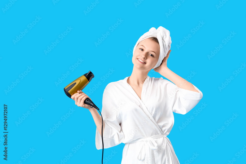 Beautiful young woman with hair dryer on blue background Beautiful young woman with hair dryer on blue background