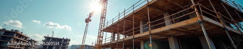 Busy construction site, bright sunny day, scaffolding visible , sky, building, bright sky