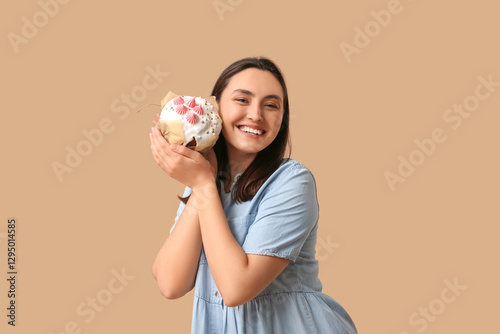 Happy young woman holding a...