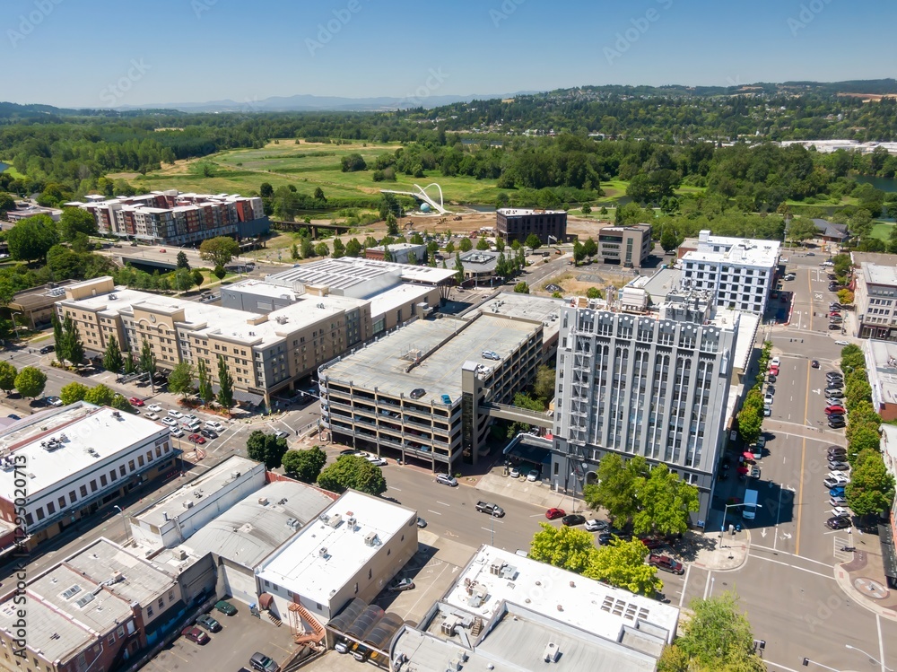 Fototapeta premium High-angle view of Salem city downtown area with various buildings, including apartments, parking garages, and a historic building. Urban development and construction are evident. , Oregon, USA