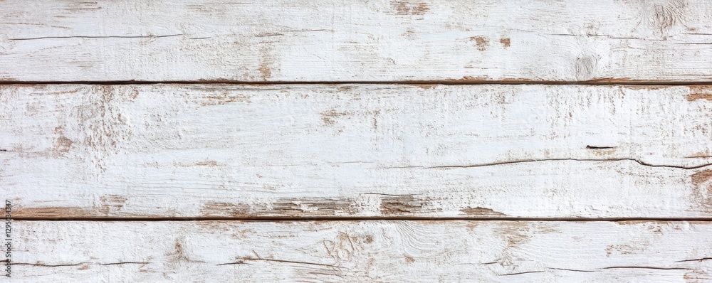 Fototapeta premium A close-up view of a white-painted wooden wall featuring a charming small window with delicate trim.