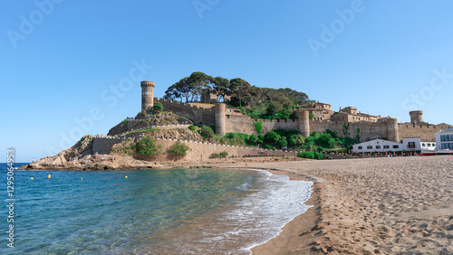 Fototapeta Naklejka Na Ścianę i Meble -  Playa de Tossa de Mar una ciudad turística mediterránea, un día soleado con cielo azul y nubes. Desde Gerona, Cataluña, España, Europa.