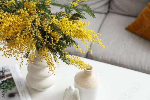 Vase with mimosa flowers on...