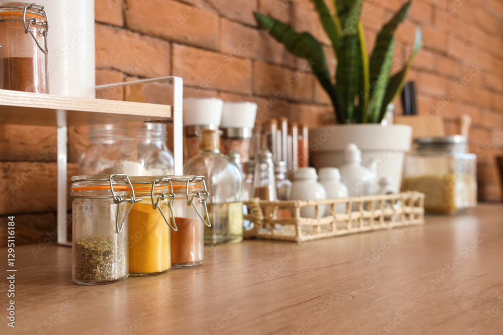 Jars with different spices on counter in kitchen, closeup Jars with different spices on counter in kitchen, closeup