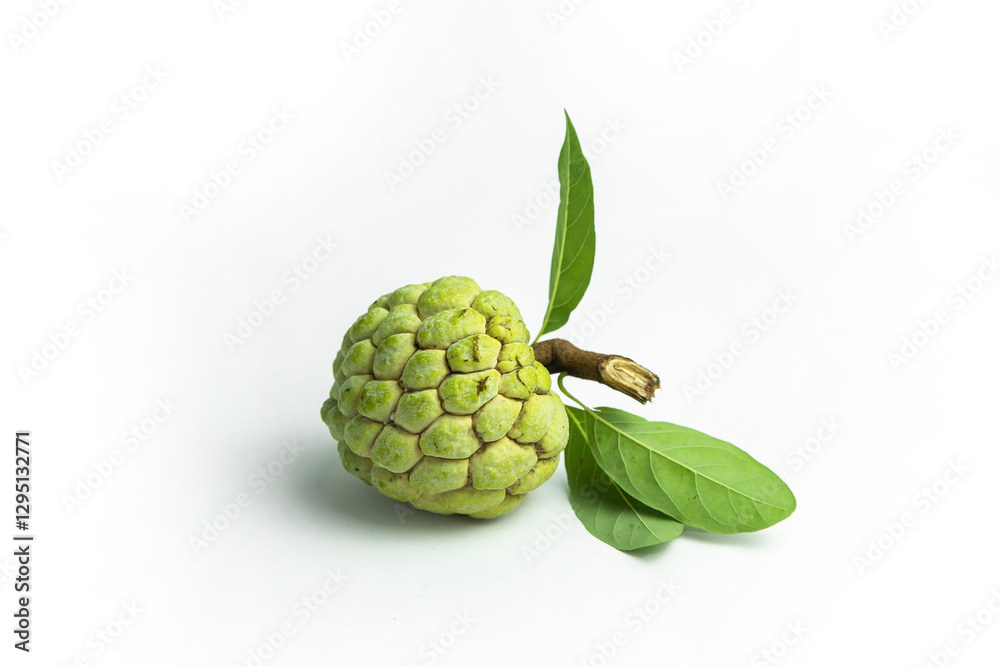 A custard apple with green leaves and a stem is isolated on a white background, viewed from a high angle A custard apple with green leaves and a stem is isolated on a white background, viewed from a high angle