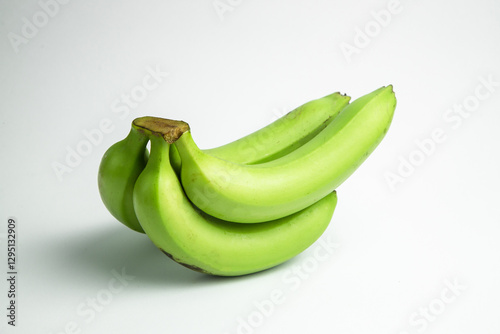 Εκτύπωση καμβά A bunch of green bananas are stacked against a white background, showing a close