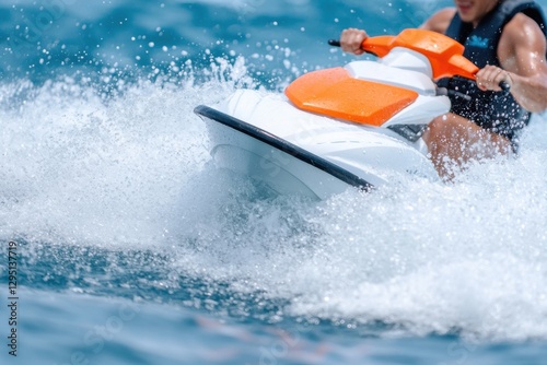 Person riding a white and orange watercraft, creating a splash of seawater.