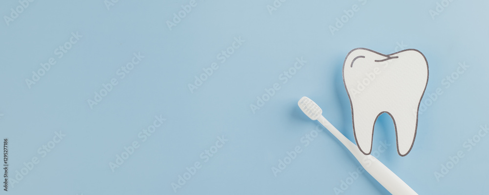 Dentist Day presents a white paper tooth model and toothbrush on blue Dentist Day presents a white paper tooth model and toothbrush on blue