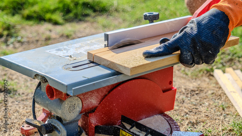 A close-up shot of a circular saw cutting timber in a garden