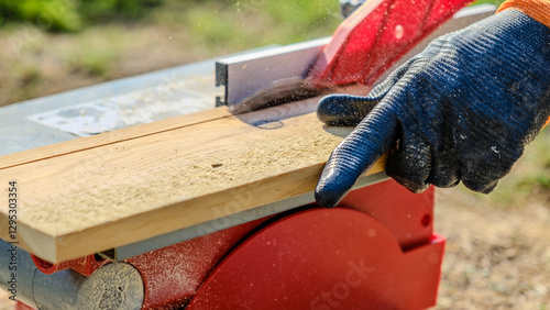 A close-up shot of a circular saw cutting timber in a garden