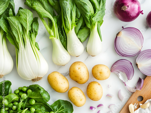 Fresh Vegetable Still Life with Bok Choy, Potatoes, Red Onions, and Green Peas on a White Marble Surface for Healthy Eating Promotion photo