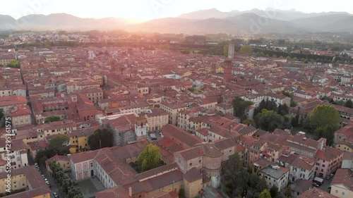 Aerial sunset evening view of famous Lucca city, known for its intact Renaissance-era city walls and well preserved historic center. Province of Lucca, Tuscany, Italy. photo