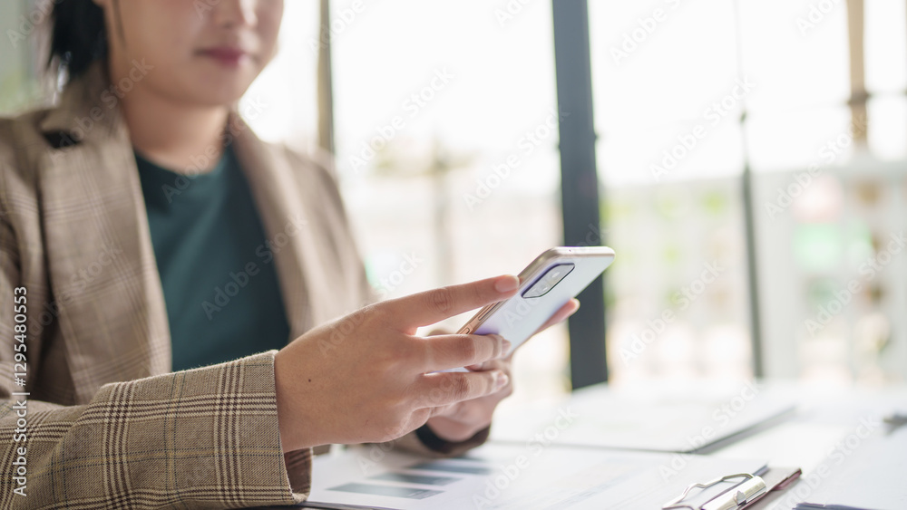 Fototapeta premium Asian Business woman using smart phone spending time checking news social media