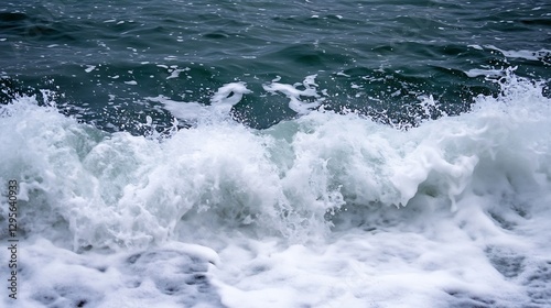 Crashing ocean waves creating foam and spray on a rocky shoreline under a cloudy sky : Generative AI