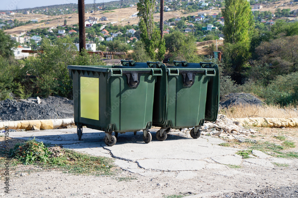 Garbage Containers Placed Along a Street in the Urban Environment Garbage Containers Placed Along a Street in the Urban Environment