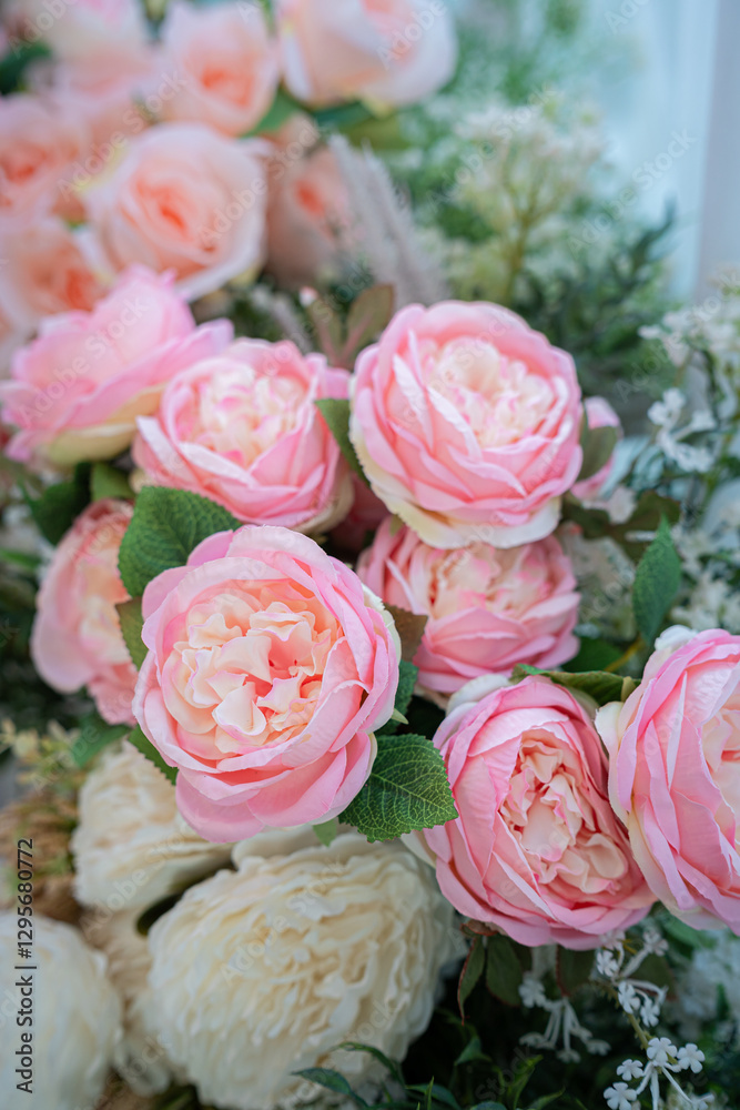 Valentine's day concept,close up Sweet color of artificial rose bouquet of red and pink roses Put with rose vase weddings interiors and decorations In a restaurant background