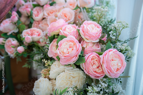 Valentine's day concept,close up Sweet color of artificial rose bouquet of red and pink roses Put with rose vase weddings interiors and decorations In a restaurant background