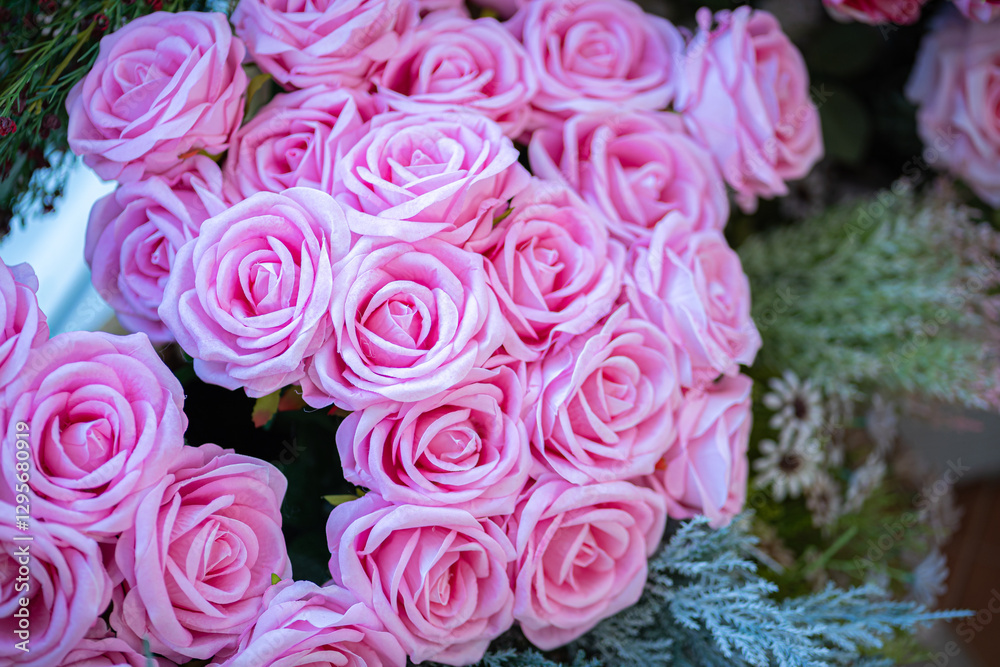 Valentine's day concept,close up Sweet color of artificial rose bouquet of red and pink roses Put with rose vase weddings interiors and decorations In a restaurant background