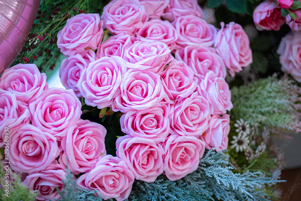 Valentine's day concept,close up Sweet color of artificial rose bouquet of red and pink roses Put with rose vase weddings interiors and decorations In a restaurant background