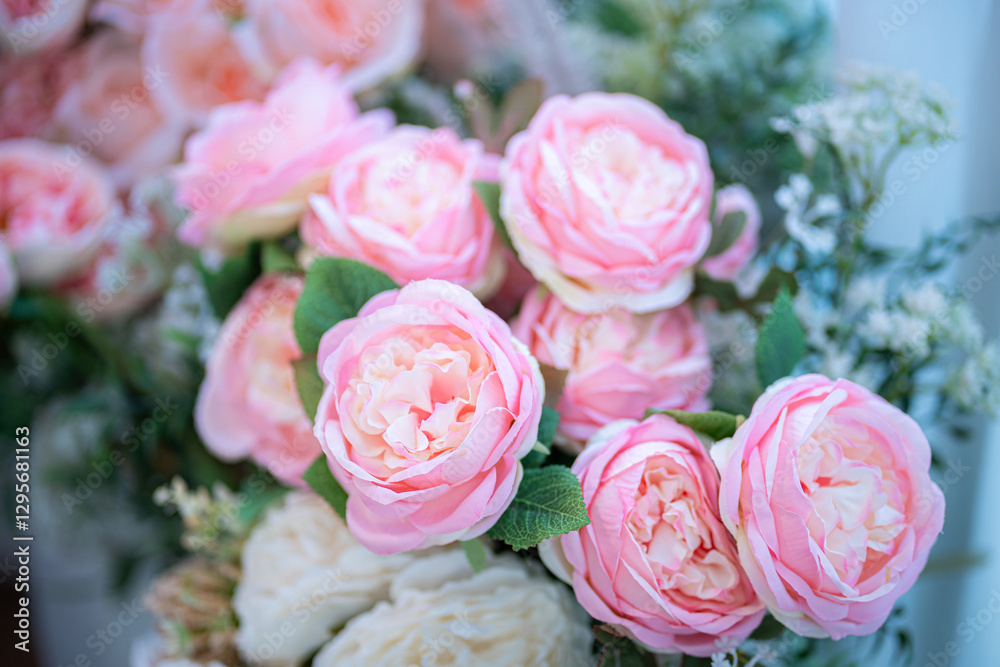 Valentine's day concept,close up Sweet color of artificial rose bouquet of red and pink roses Put with rose vase weddings interiors and decorations In a restaurant background