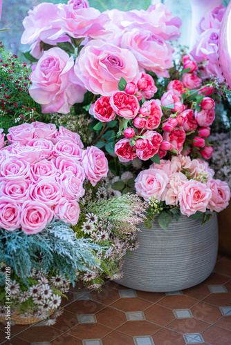 Valentine's day concept,close up Sweet color of artificial rose bouquet of red and pink roses Put with rose vase weddings interiors and decorations In a restaurant background
