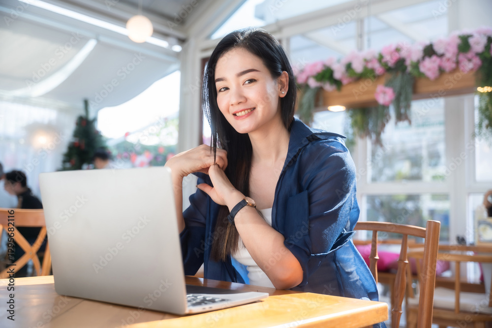 Asian freelance people business female talking making using casual working with laptop computer and coffee at home in the living room indoors artificial rose bouquet of red and pink roses rose vase