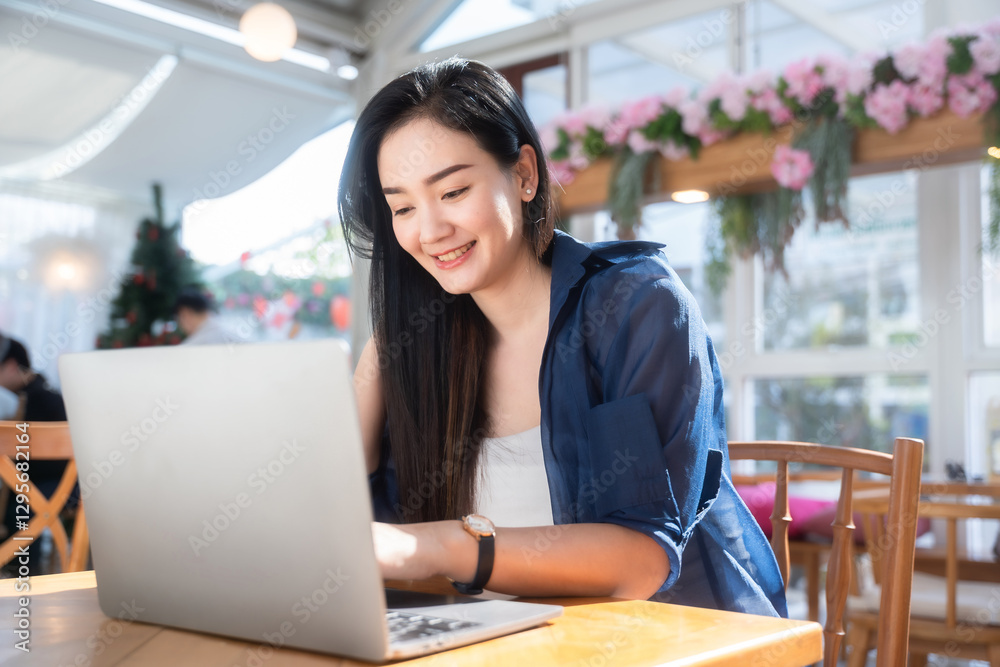 Asian freelance people business female talking making using casual working with laptop computer and coffee at home in the living room indoors artificial rose bouquet of red and pink roses rose vase