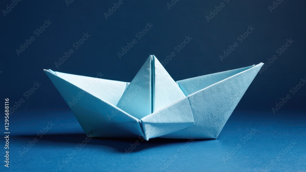 a delicate blue origami boat floating against a deep blue background a delicate blue origami boat floating against a deep blue background