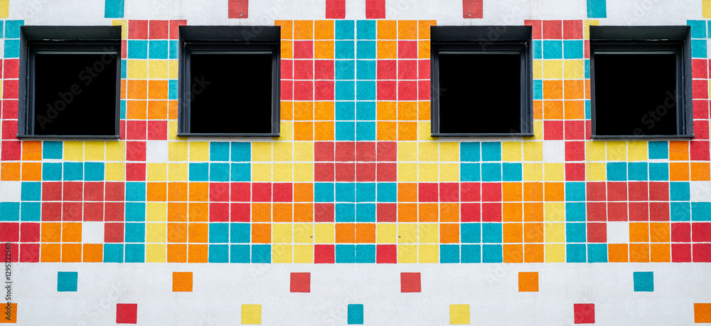 vibrant, colorful wall painted with a pixelated design and four windows vibrant, colorful wall painted with a pixelated design and four windows
