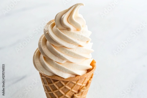 soft-serve ice cream cone with swirled top on white photo