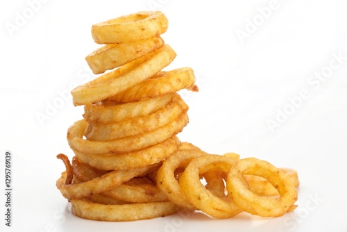 curly fries stacked in a pile on white photo