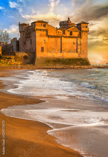 Obraz na płótnie Great Medieval castles of Italy - beautifil Castello Santa Severa on the beach over sunset. Lazio region. drammatic sea beach landscape w salonie