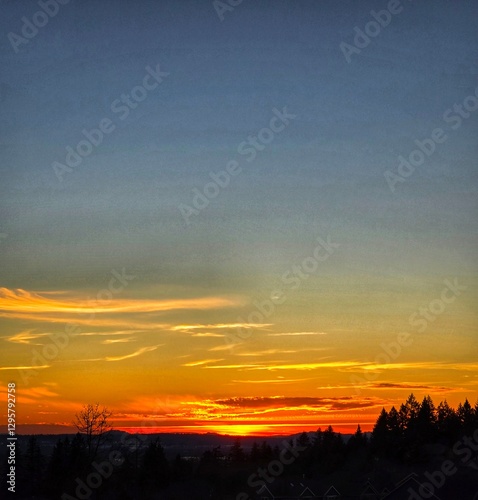 A breathtaking yellow-orange summer sunset over the Columbia River in the Pacific Northwest.