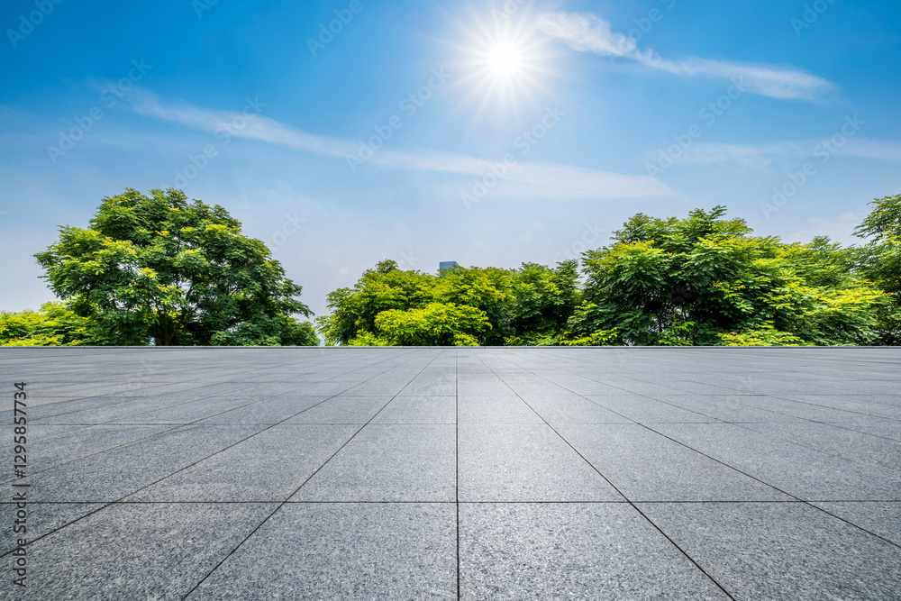 Empty square floor and green trees under blue sky