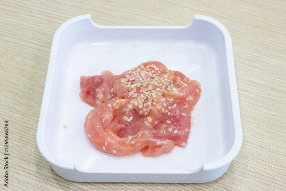 Marinated pork until tender, sprinkled with white flour on a white tray, ready to serve as shabu. Marinated pork until tender, sprinkled with white flour on a white tray, ready to serve as shabu.