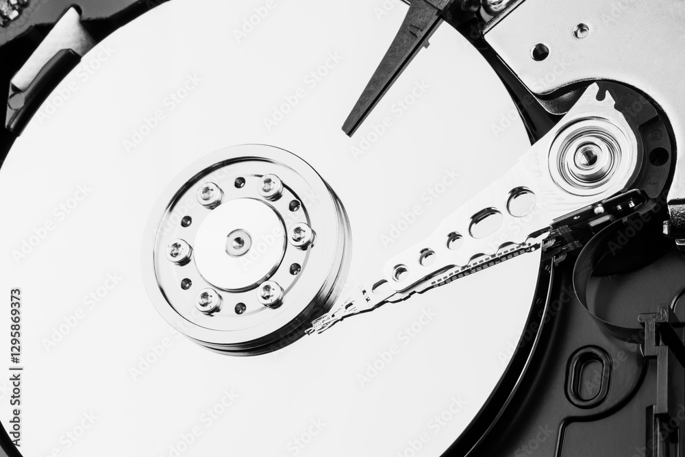 Close-up of the mechanism of a disassembled computer hard disk in black and white photo