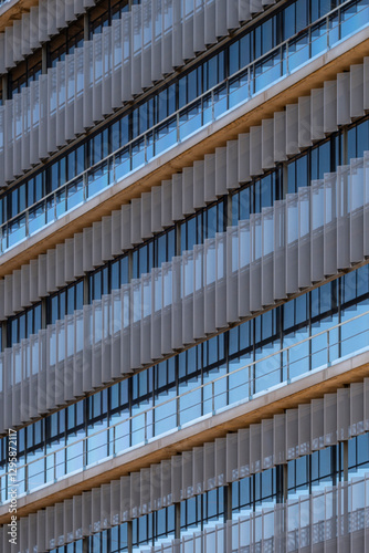 Urban corporate architecture with alternating glass and metal panels.