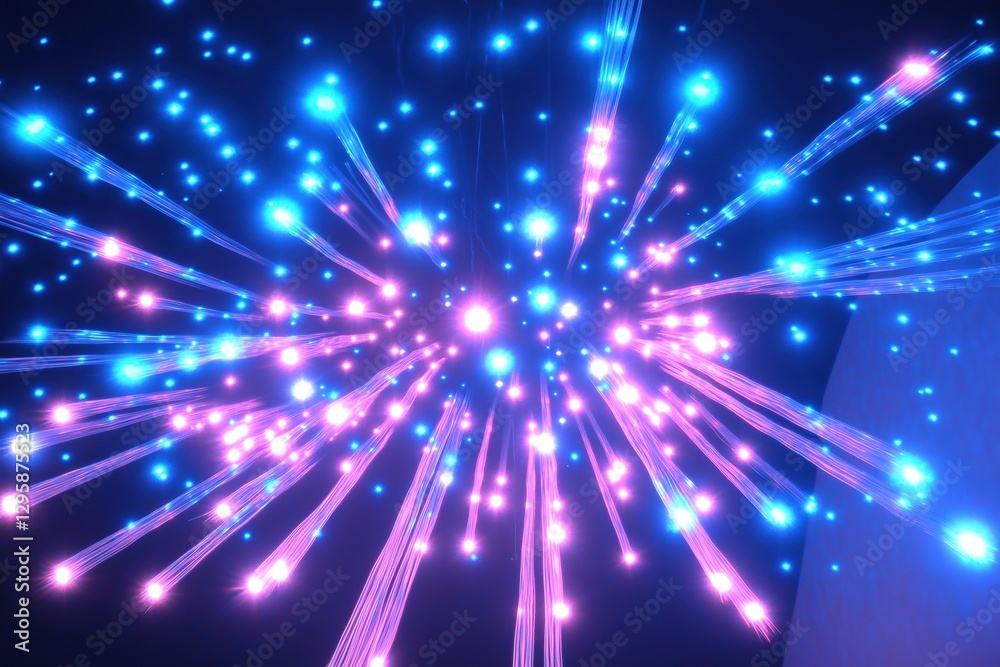 Obraz premium A vibrant display of colorful lights resembling fireworks, with blue and pink hues radiating outward against a dark background.