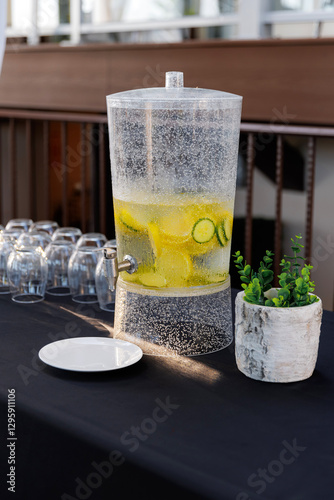 Wallpaper Mural Cool refreshing lemonade in a jug close-up. A cold drink with bubbles and slices of lemon stands outdoors. Fresh cold lemonade in a glass siphon and empty glasses for a treat. Summer refreshing drink Torontodigital.ca