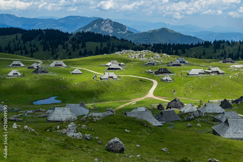 Velika Planina, Kamnik, Slovenia. Lord of the Rings style village. Wooden typical houses, hills, green meadows, flowers where cows and calfs graze. High quality artisanal milk and cheeses. Holiday.