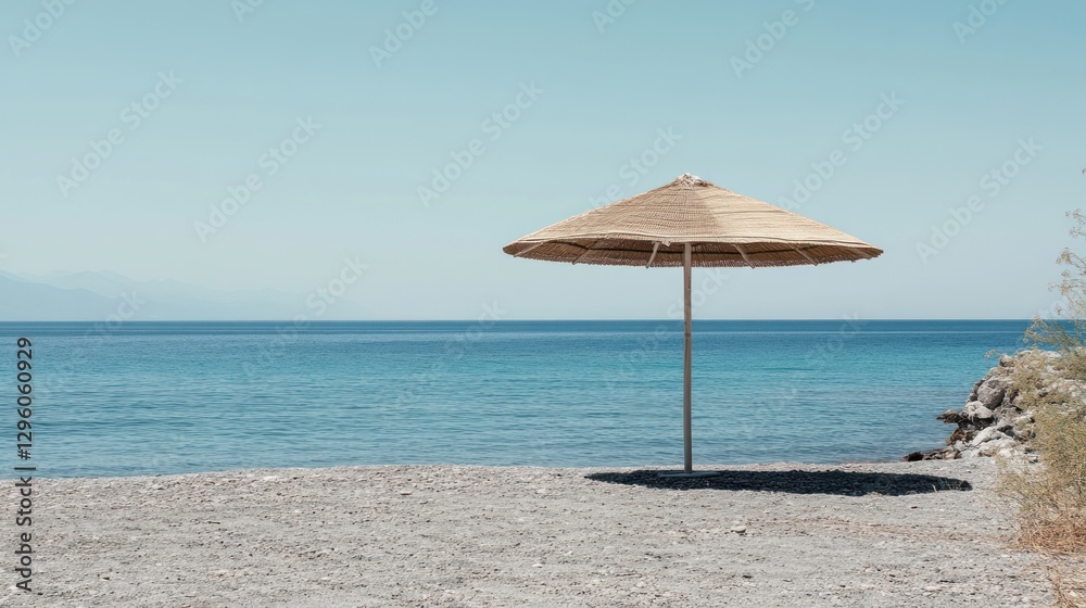 Solitary Straw Beach Umbrella Overlooking Calm Ocean Solitary Straw Beach Umbrella Overlooking Calm Ocean