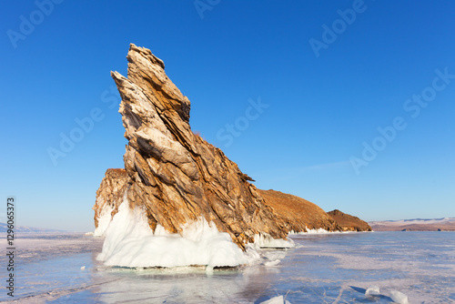 Wallpaper Mural Scenic winter landscape of frozen Baikal Lake. View of Dragon Cape on edge of Ogoy Island - natural landmark, popular place of tourists against background of blue sky in sunny day. Natural background Torontodigital.ca