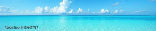 Crystal clear turquoise waters under blue sky with white fluffy clouds, blue, view