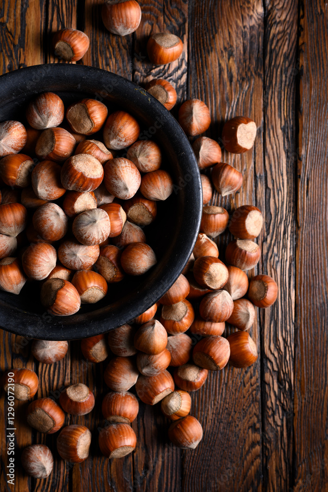 Hazelnut nuts pour out of wooden rustic table close up. Food photography Hazelnut nuts pour out of wooden rustic table close up. Food photography