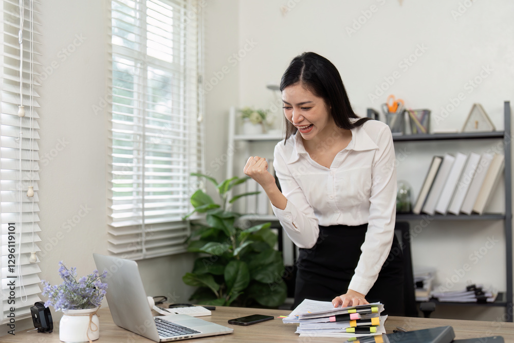Excited accountant celebrating achievements in a bright office space. Excited accountant celebrating achievements in a bright office space.