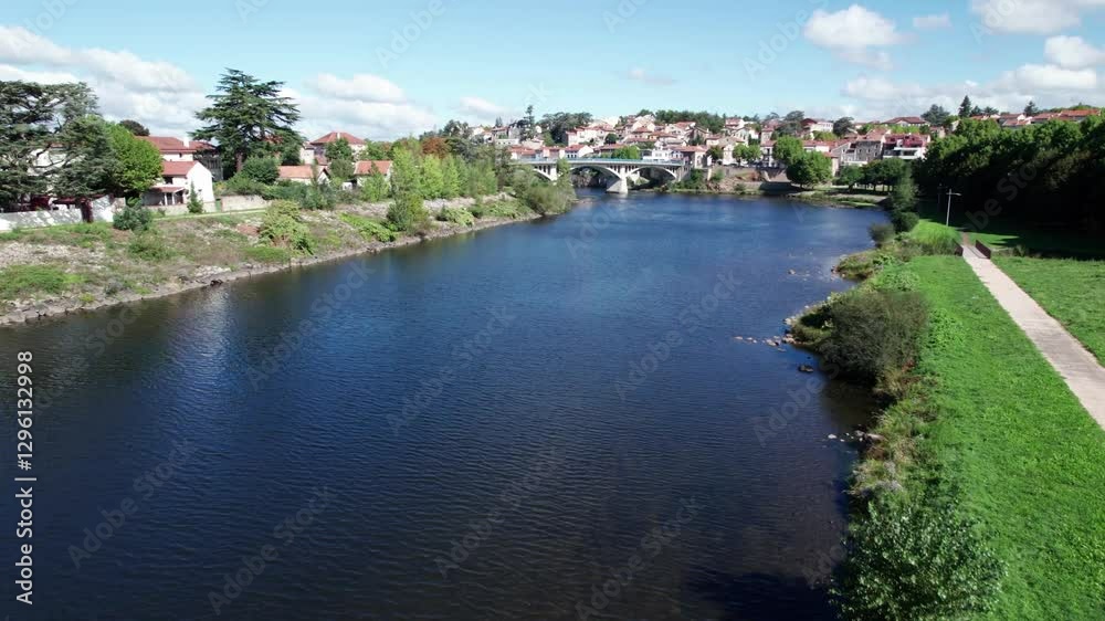 aerial shot over the loire river in Saint Just Saint Rambert, revealing the bridge crossing the river, Loire departement, Auvergne Rhone Alpes region, France