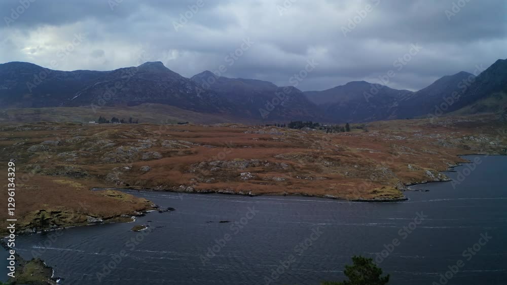 Aerial pullback and ascend over Pine Island, unveiling Connemara’s dramatic landscape under stormy blue light Aerial pullback and ascend over Pine Island, unveiling Connemara’s dramatic landscape under stormy blue light