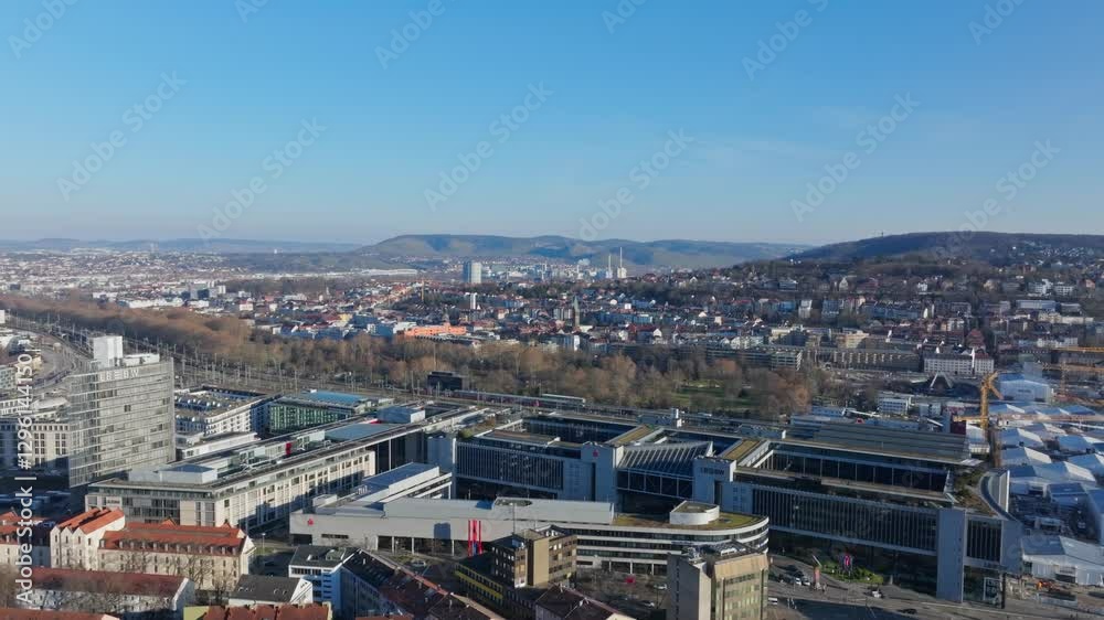 Aerial view panning across the Central Train Station of Stuttgart, showcasing modern buildings including LBBW banking and administration center Aerial view panning across the Central Train Station of Stuttgart, showcasing modern buildings including LBBW banking and administration center